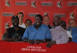 Caleb his family and coaches at signing day.